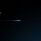 Illustration of a fast radio burst (FRB) traveling from its host galaxy to Earth.